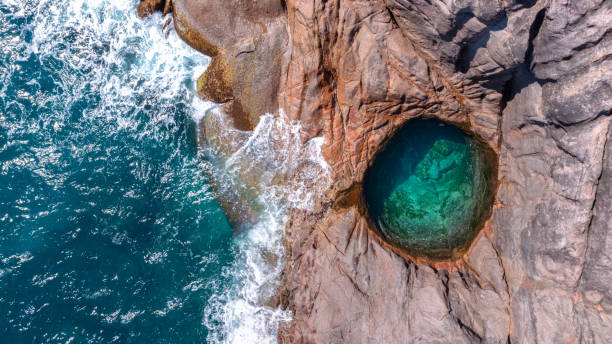 The Rock Pool at Takamaka Beach from above on the Island Mahé in the Seychelles Aerial view of the natural Rock Pool at Takamaka Beach on Mahé in the Seychelles mahe island stock pictures, royalty-free photos & images