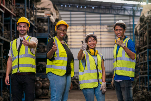 Group of employees and engineers in industrial plants. Team of workers and engineer showing thumb up in Factory at production. stock photo