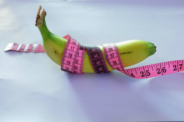 istock banana with measuring tape on white background 1346357346