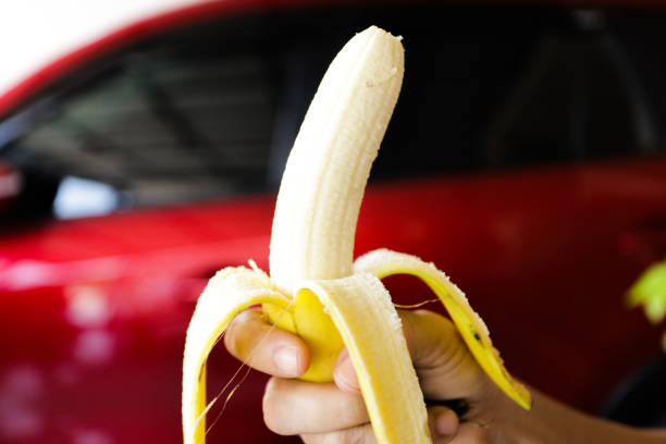 istock hand holding a peeled banana 1346357823