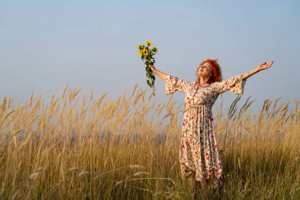 Photo of Senior red haired woman breathes fresh air