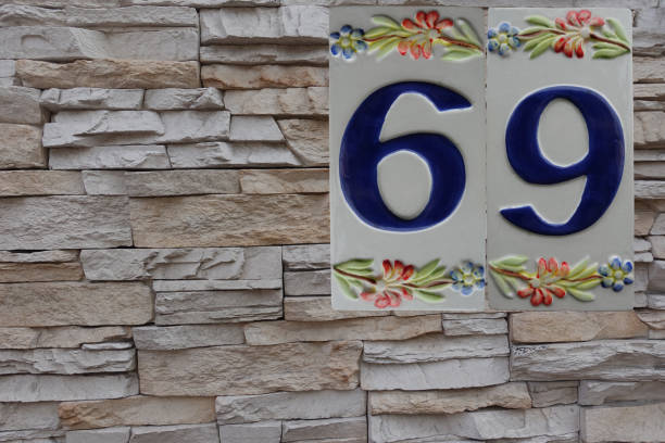 istock Street  Number 69   Ceramic plate placed on a house stone facade 1346359331