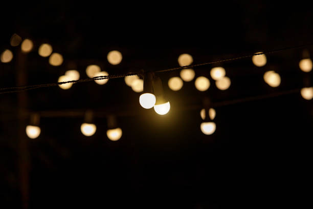 istock Electric incandescent bulbs with warm yellow light. 1346361228