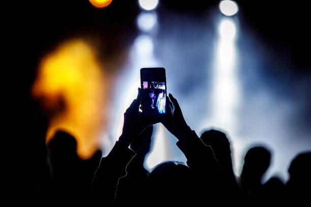 istock Fan taking photo with smartphone at a concert. 1346363120