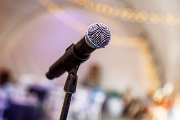 istock Microphone on stage against a background of the hall. 1346363144