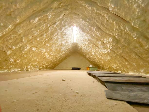 Attic pumped with spray foam insulation to reduce heat loss stock photo