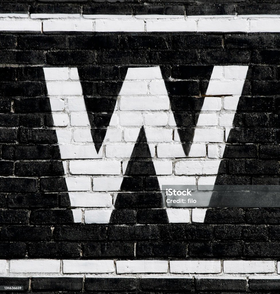 Letter "W" A white letter "W" on a black background. Detail from a sign. Alphabet Stock Photo