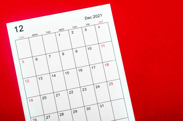 istock december 2021 calendar sheet on red dark background. 1346366626