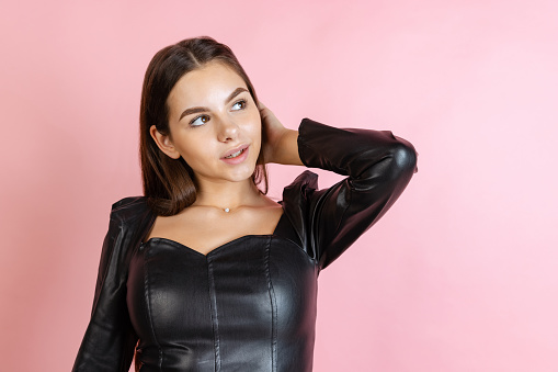 Beauty treatment, cosmetology. Portrait of beautiful Caucasian woman posing isolated over pink background. Concept of beauty, youth, fashion, facial expression, emotions, lifestyle. Copy space for ad