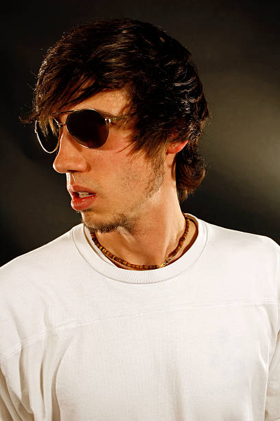 Hipster A serious young man in sunglasses. emo boy stock pictures, royalty-free photos & images