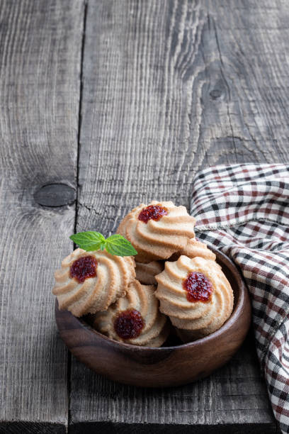 istock Qurabiya cookie shortbread with jam on rustic wooden table 1346368406
