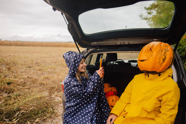 istock Smiling couple having fun after pumpkins picking 1346369726