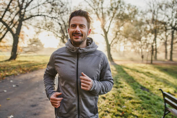 istock Active man running in park at autumn morning 1346369730