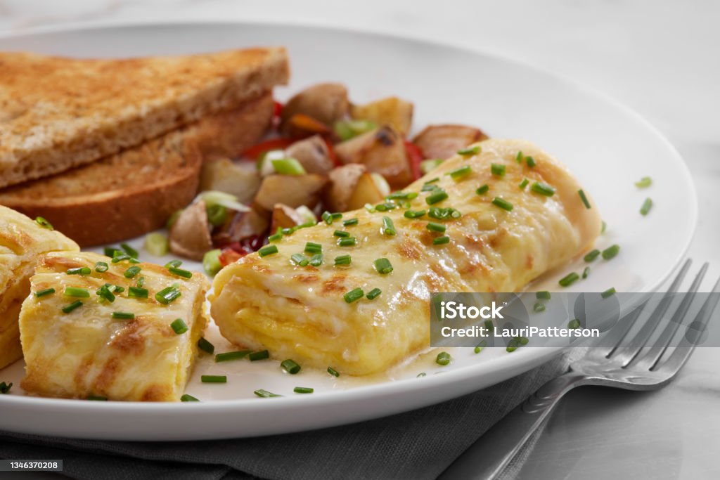 Cheesy Classic French Omelette Cheesy Classic French Omelette with Breakfast Sausage, Hash Browns and Toast Omelet Stock Photo