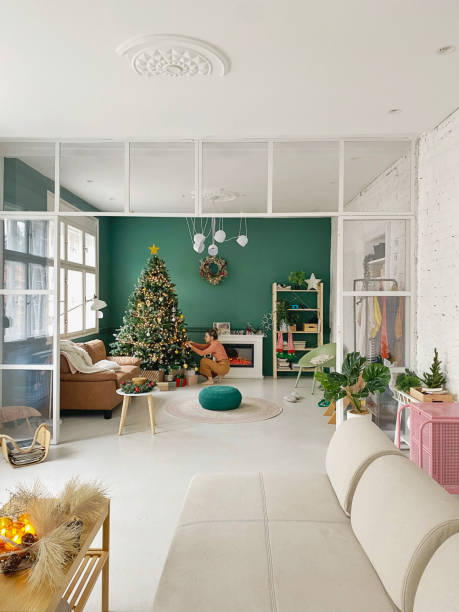 istock Young woman decorating a Christmas tree 1346371009