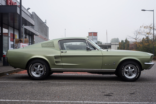 Mulhouse - France - 10 October 2021 - Profile view of Ford mustang 1967 fastback parked in the street