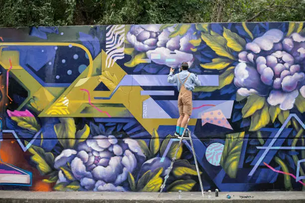 Photo of Graffiti Artist Painting On Wall.