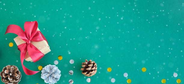 istock Eco friendly Christmas composition with gift boxes in craft reusable paper and natural decor on green background top view. 1346374333