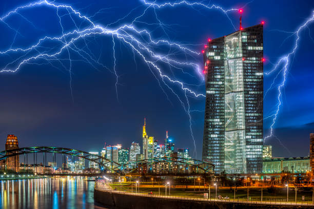 the ecb (european central bank) in frankfurt am main in front of the night sky with lightning strikes - flowing water flash imagens e fotografias de stock