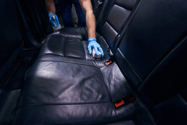 istock Worker dry-cleaning car seats during valeting service 1346375812