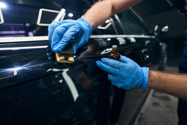 istock Person applying coating on car surface scratches 1346376008