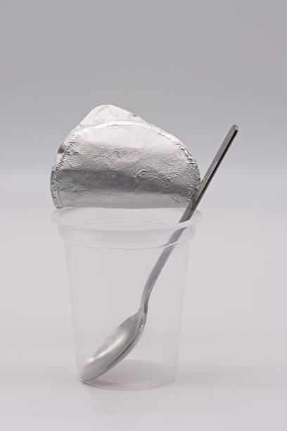 istock empty clear yogurt cup with aluminum foil and spoon 1346379756