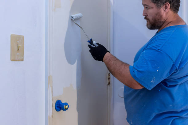 istock Worker painting using paint roller on layer white color a door frame trim 1346380545