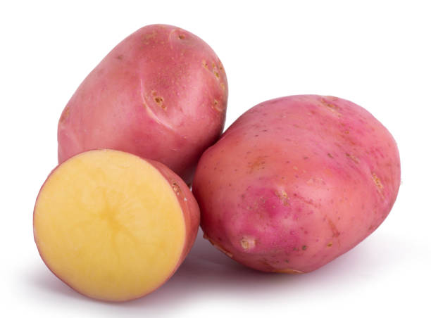 whole and sliced potato, isolated on white background close up - raw potato human skin red pink imagens e fotografias de stock
