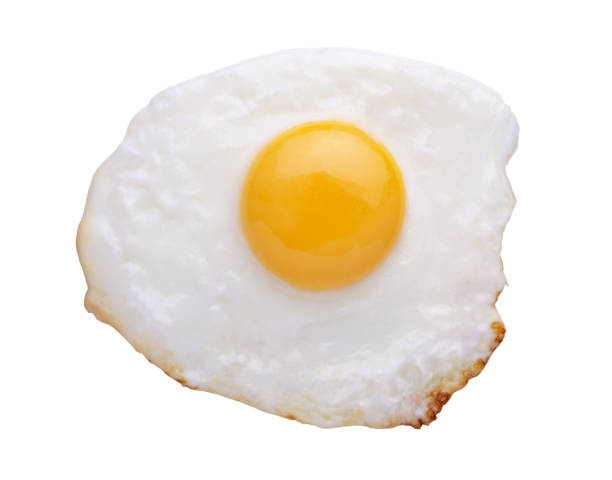 istock Fried egg and yolk close up isolated on white background 1346380738
