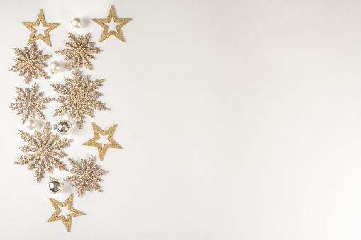 Christmas Holidays Composition. Celebratory, creative gold Christmas snowflakes on a white background. Flat lay, top view.