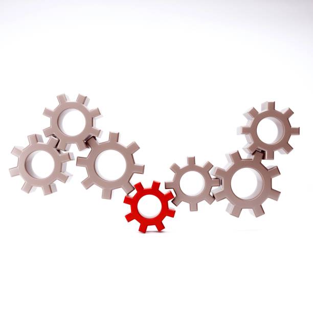 istock Small group of gears with their teeth engaged on a white background 1346384702
