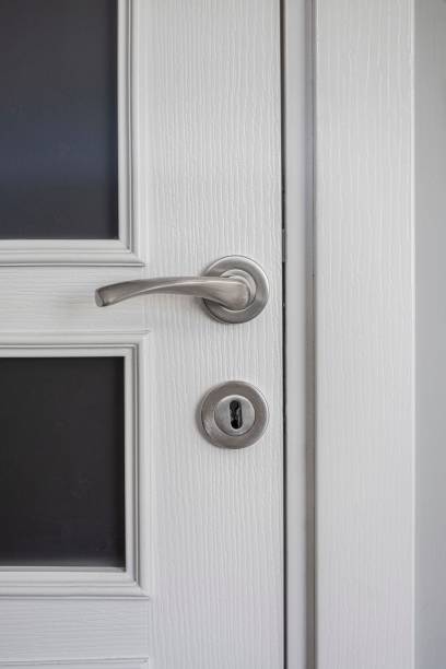 istock Door handle on wooden door 1346385637
