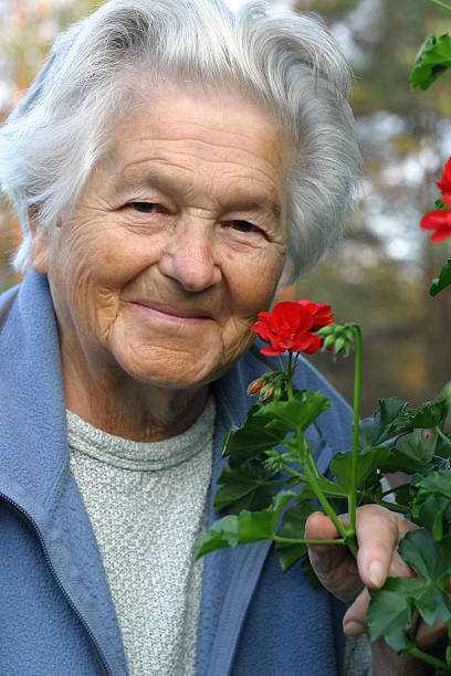 istock elderly woman and flowers 134638678