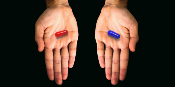 istock Red and blue pills capsules tablets in opened hands isolated on black background. 3d illustration 1346388122