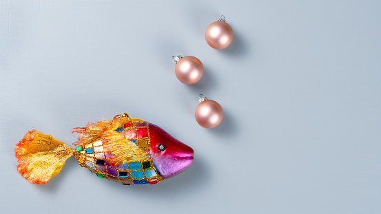 Christmas composition. Christmas balls as bubbles and fish on a gray table. Top view, copy space.