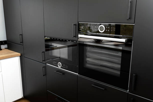 istock Modern kitchen with black fronts, built in oven and microwave, vinyl panels on the floor. 1346390295