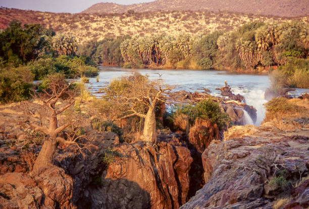 Epupa Falls on the Kunene River. Epupa Falls are located along the Kunene River which marks the border between Angola and Namibia. kaokoveld stock pictures, royalty-free photos & images