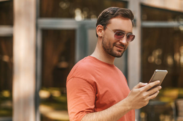 istock Satisfied man reading message in smartphone 1346393735