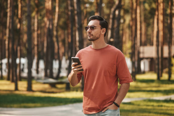 istock Man in sunglasses with smartphone in hand 1346393752