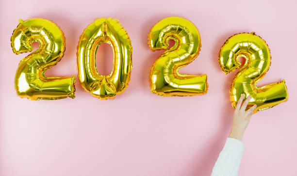 istock Happy new year 2022. Hand with white sleeve placing the number 2. Copy space. 1346395021