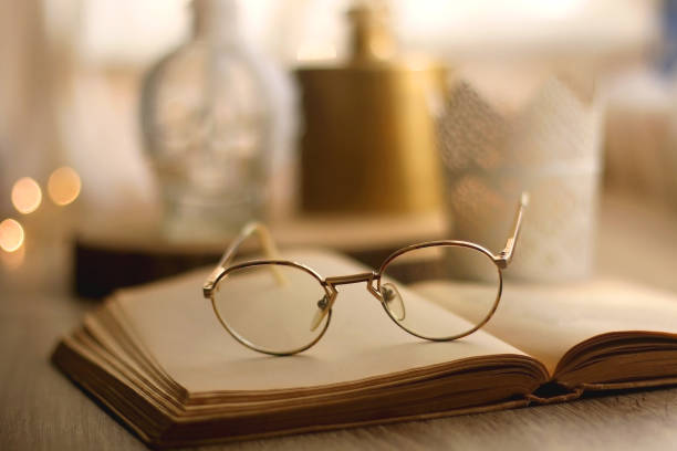 istock Book, Reading Glasses and Candles 1346397144