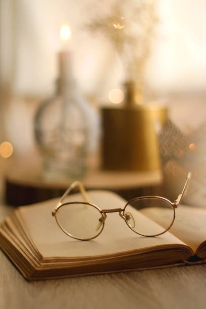 istock Book, Reading Glasses and Candles 1346397147