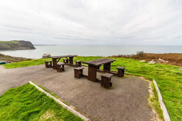 istock Two picnic tables with spectacular view behind. 1346398395