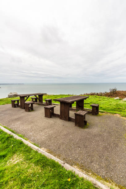 istock Two picnic tables with spectacular view behind. 1346398444