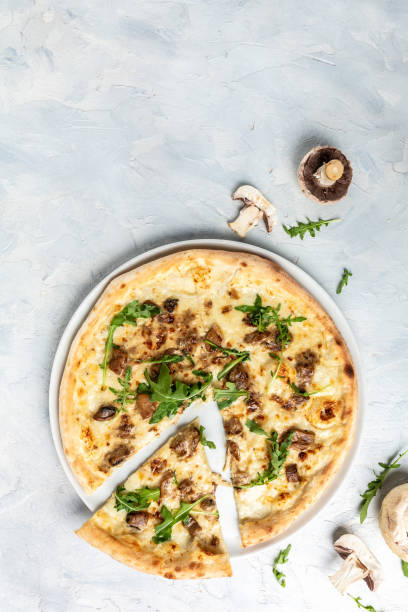 istock Mushroom Pizza, mozzarella, mushrooms and arugula. vertical image. top view. place for text 1346400603