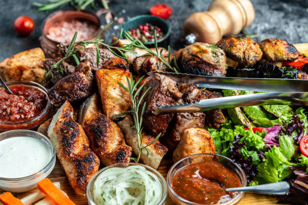 istock Grilled assorted meat and vegetables on tray. Grill Barbecue menu. Restaurant menu, dieting, cookbook recipe 1346401180