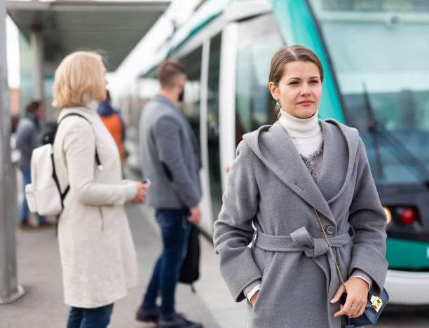 istock Woman waiting for tram at public stop 1346401889