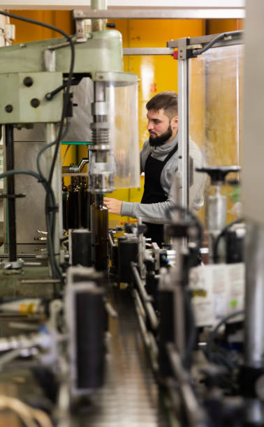 istock Young man working on olive oil bottling line 1346402902