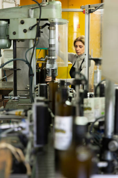 istock Woman working on olive oil bottling line 1346402904
