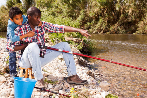 istock Fishermen - boy and his father 1346403052